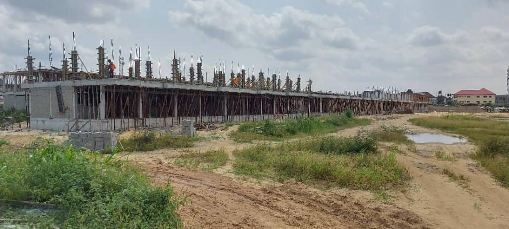 A long concrete frame rising across the Toll Heights site